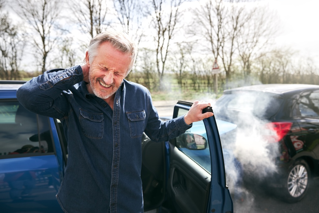 Senior Male Driver With Whiplash Injury Getting Out Of Car After Traffic Accident | Doc Sawyer Chiropractic Senior male driver with whiplash injury getting out of car after traffic accident
